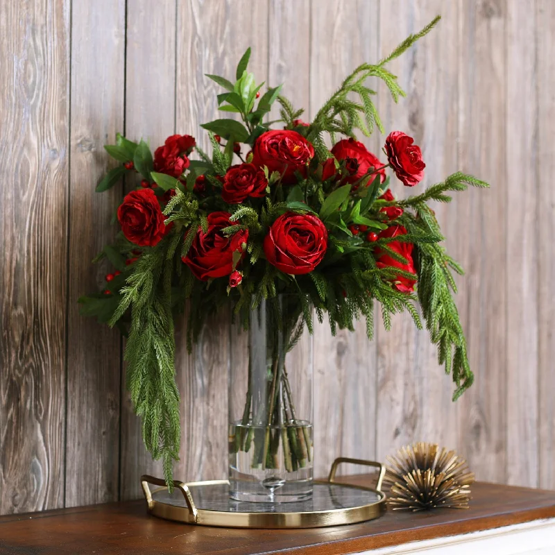 Holiday Grandeur - Red Rose, Ranunculus, Norfolk Pine & Laurel Draping Christmas Floral Arrangement in Tall Glass Vase